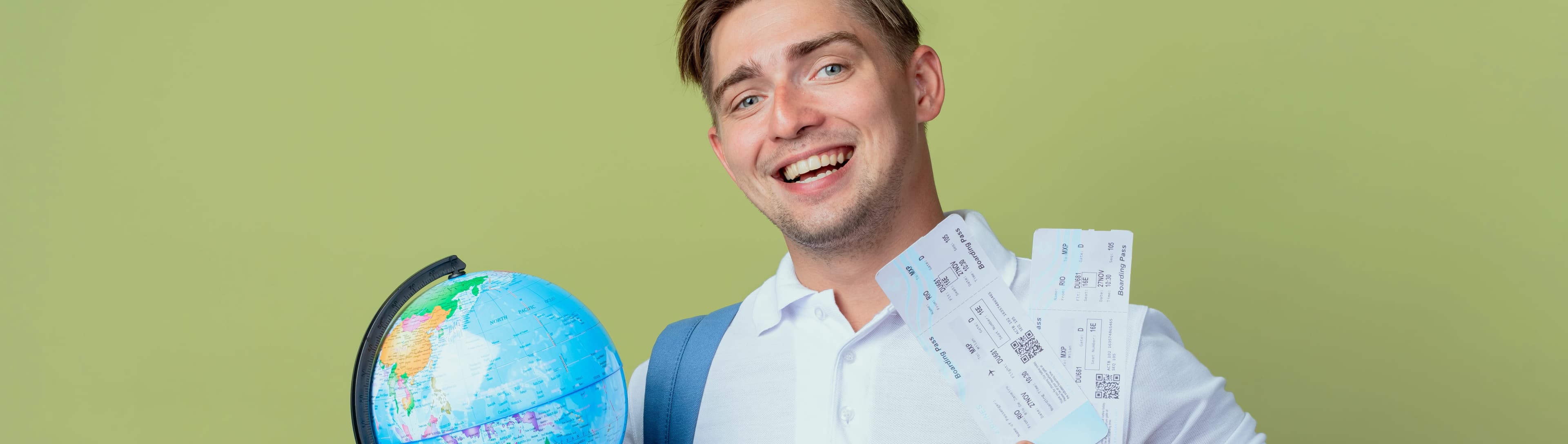 1765525190747-HERO-smiling-young-handsome-male-student-wearing-back-bag-holding-tickets-globe-isolated-olive-green.jpg
