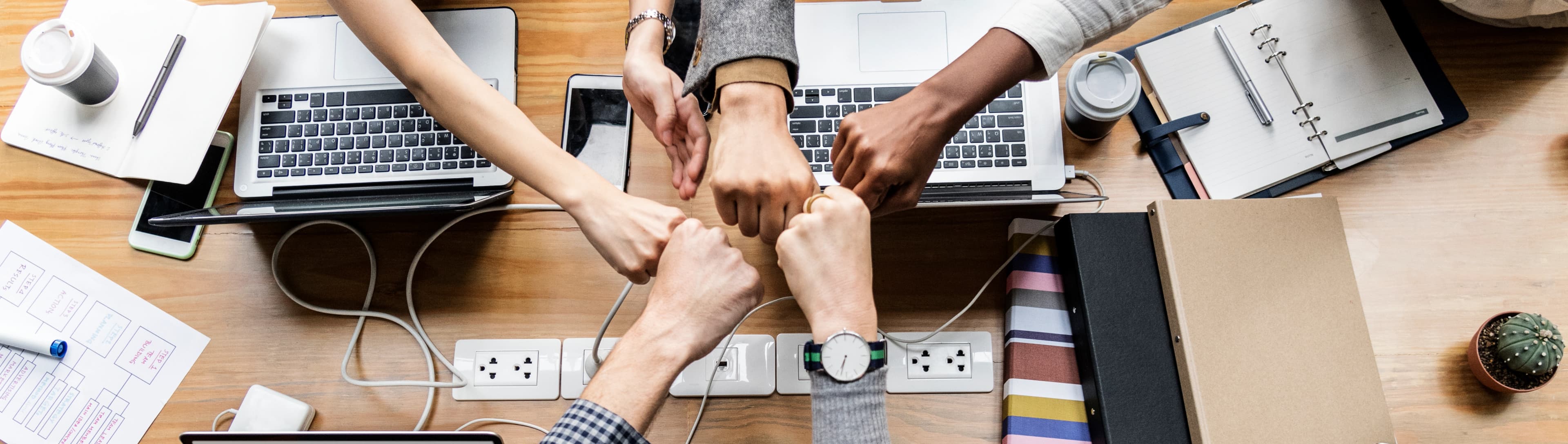 1778749217790-HERO-colleagues-giving-fist-bump.jpg